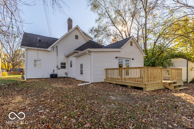 rear view of house with central air condition unit and a wooden deck