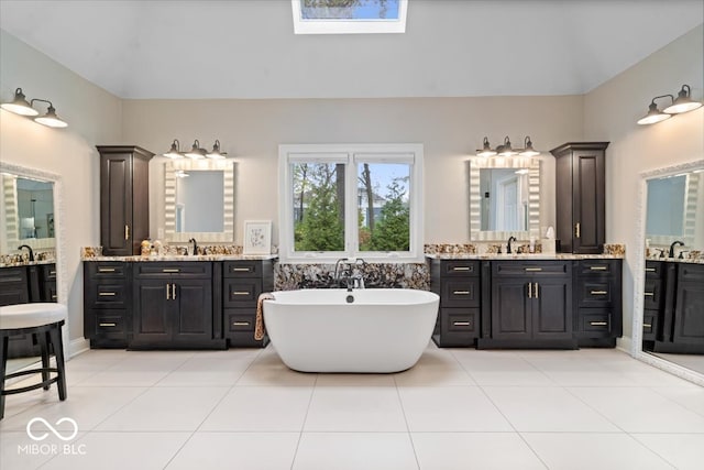 bathroom with vanity, a bathing tub, and tile patterned flooring