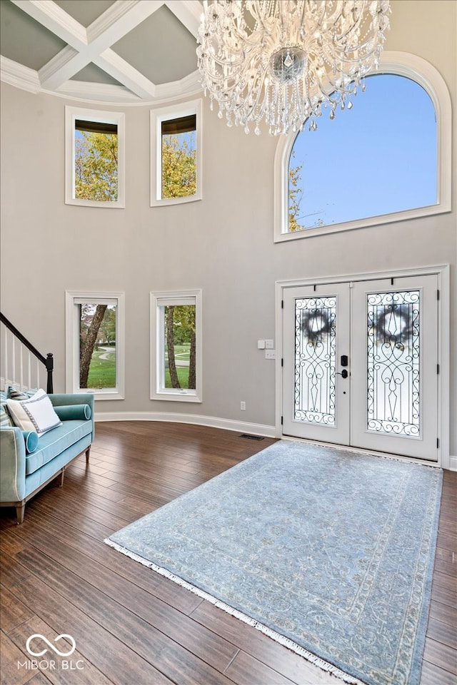 entryway featuring french doors, a notable chandelier, dark hardwood / wood-style floors, and coffered ceiling