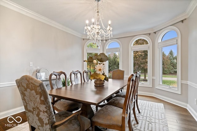 dining space featuring an inviting chandelier, crown molding, and dark wood-type flooring