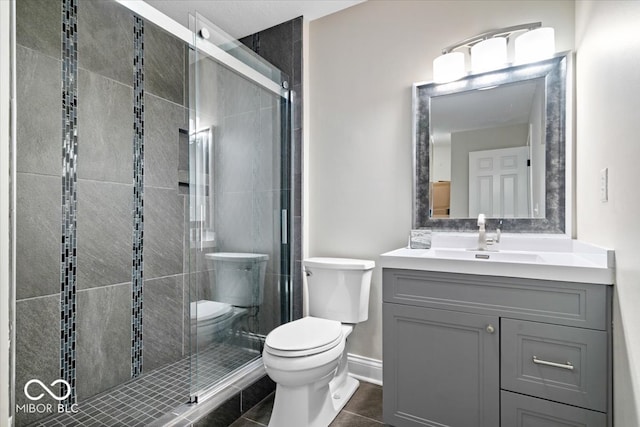 bathroom featuring vanity, tile patterned floors, toilet, and an enclosed shower