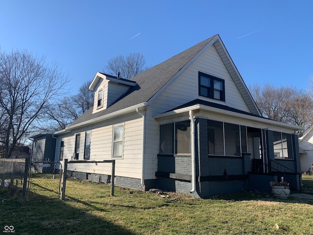 view of side of property with a yard and a sunroom