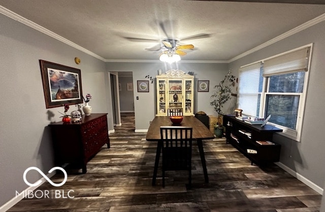 dining space featuring crown molding, dark wood-type flooring, a textured ceiling, and ceiling fan