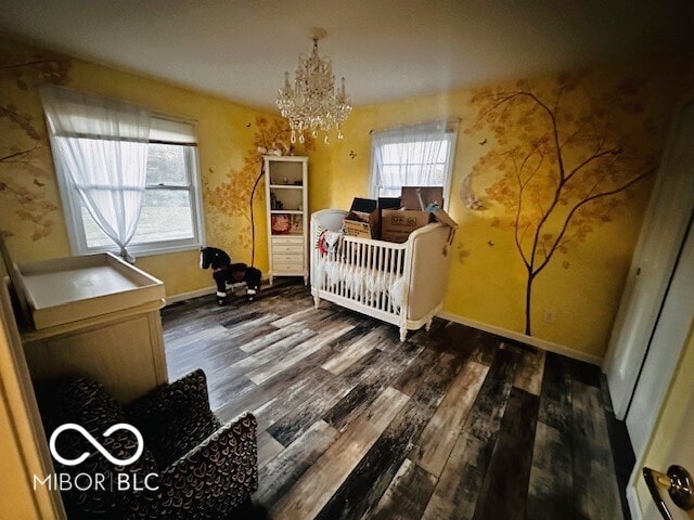 bedroom featuring dark hardwood / wood-style floors and a chandelier