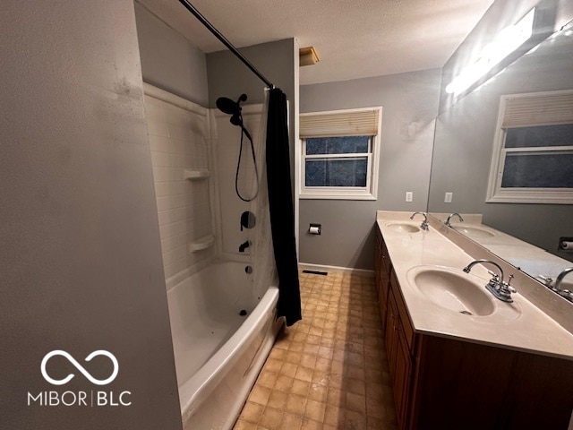 bathroom with vanity, shower / tub combo, and a textured ceiling