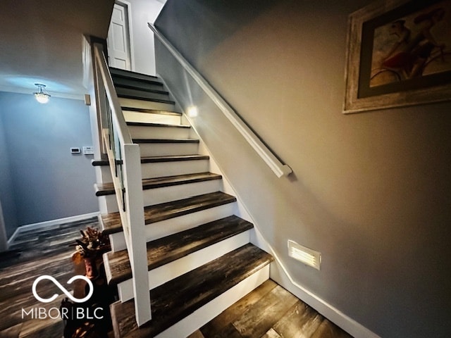 stairs featuring hardwood / wood-style flooring