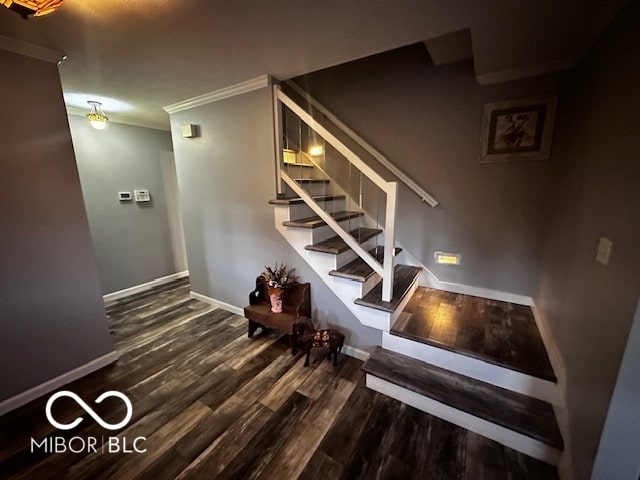 stairs with crown molding and hardwood / wood-style floors