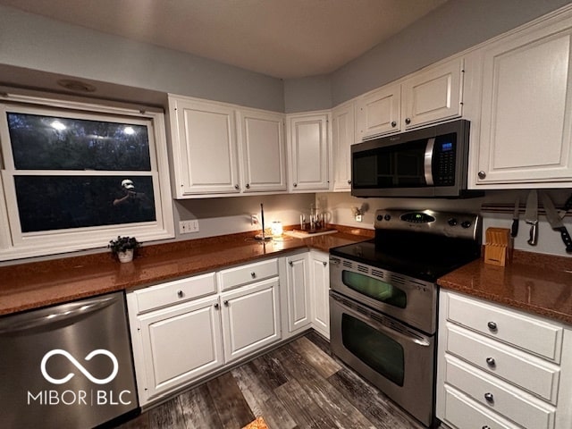 kitchen featuring stainless steel appliances and white cabinets