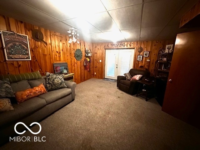 living room featuring wood walls and carpet flooring