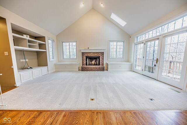 unfurnished living room with a skylight and a wealth of natural light