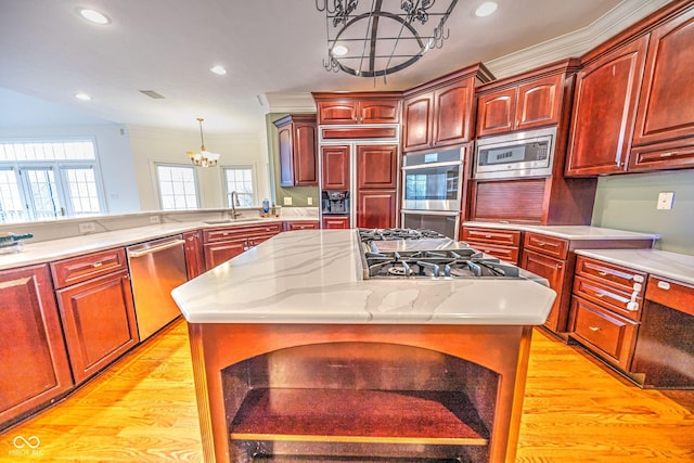 808 Copperfield Xing, Danville, IN 46122 - kitchen with a chandelier, stainless steel appliances, ornamental molding, reddish brown cabinets, and a sink