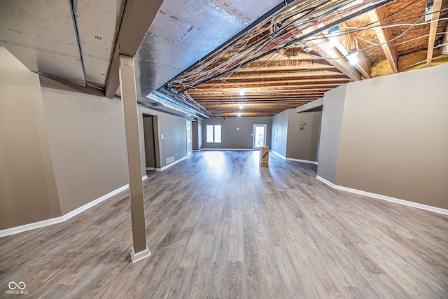 basement featuring wood-type flooring