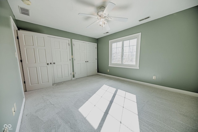 808 Copperfield Xing, Danville, IN 46122 - unfurnished bedroom featuring multiple closets, carpet floors, baseboards, and ceiling fan