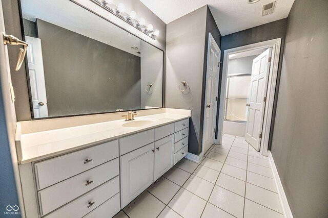 808 Copperfield Xing, Danville, IN 46122 - bathroom featuring tile patterned floors, vanity, baseboards, and  shower combination