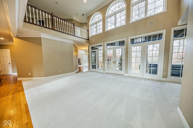 808 Copperfield Xing, Danville, IN 46122 - unfurnished living room with ornamental molding, baseboards, a towering ceiling, carpet flooring, and recessed lighting