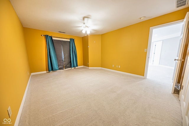 unfurnished room featuring light carpet and ceiling fan