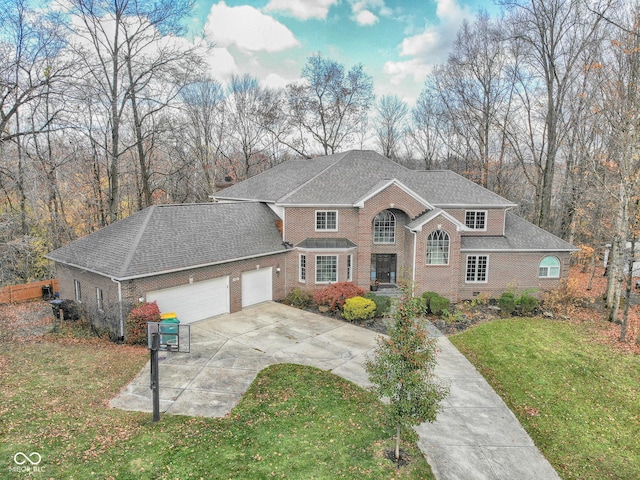 808 Copperfield Xing, Danville, IN 46122 - traditional-style house featuring driveway, an attached garage, brick siding, a front yard, and a shingled roof