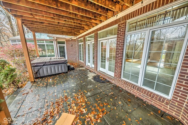 view of patio / terrace with a hot tub