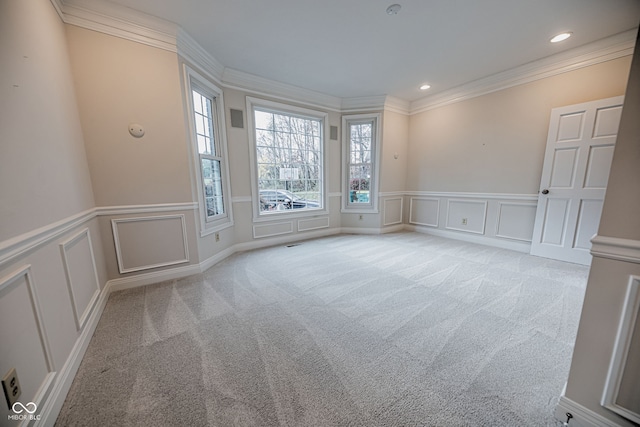 carpeted spare room featuring ornamental molding