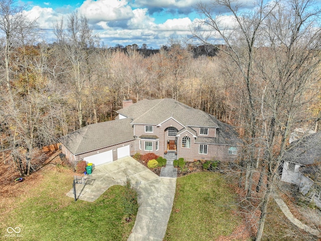 808 Copperfield Xing, Danville, IN 46122 - view of front of house with concrete driveway, a front lawn, a garage, and a chimney