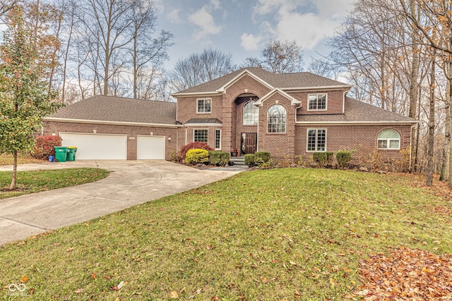 view of front property featuring a garage and a front yard