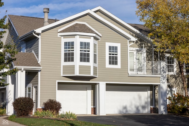 view of front of house with a balcony and a garage