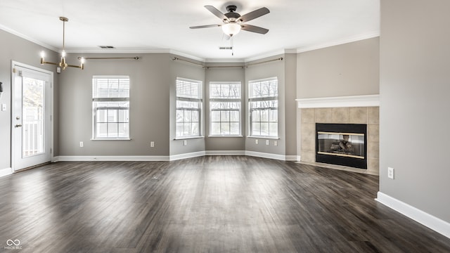 unfurnished living room with dark hardwood / wood-style floors, a healthy amount of sunlight, and crown molding