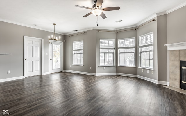 unfurnished living room featuring ornamental molding, dark wood-type flooring, a healthy amount of sunlight, and a tile fireplace