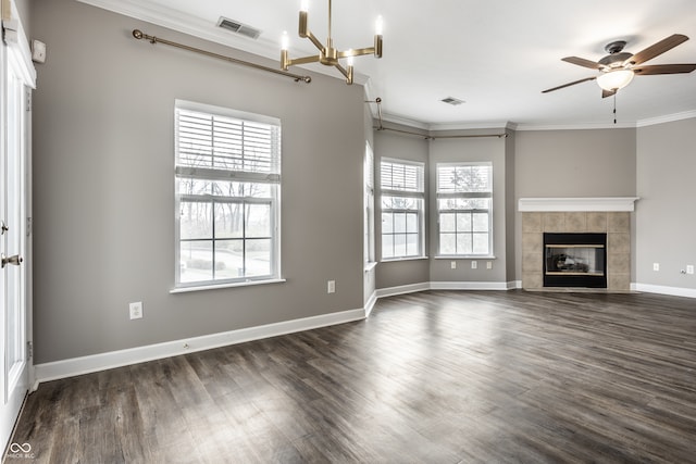 unfurnished living room featuring a fireplace, a wealth of natural light, dark hardwood / wood-style floors, and crown molding