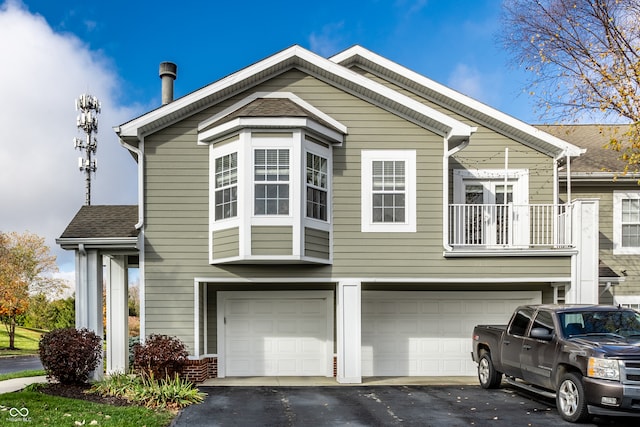 view of front of house featuring a garage and a balcony