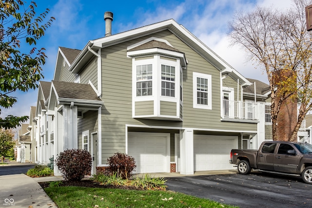 view of front property with a balcony and a garage