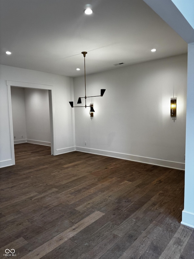 unfurnished room with dark wood-type flooring