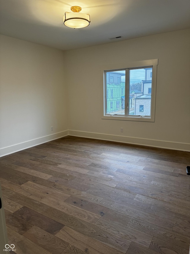 empty room with dark hardwood / wood-style floors