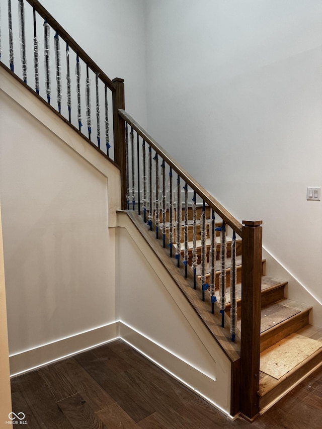 stairs featuring hardwood / wood-style flooring