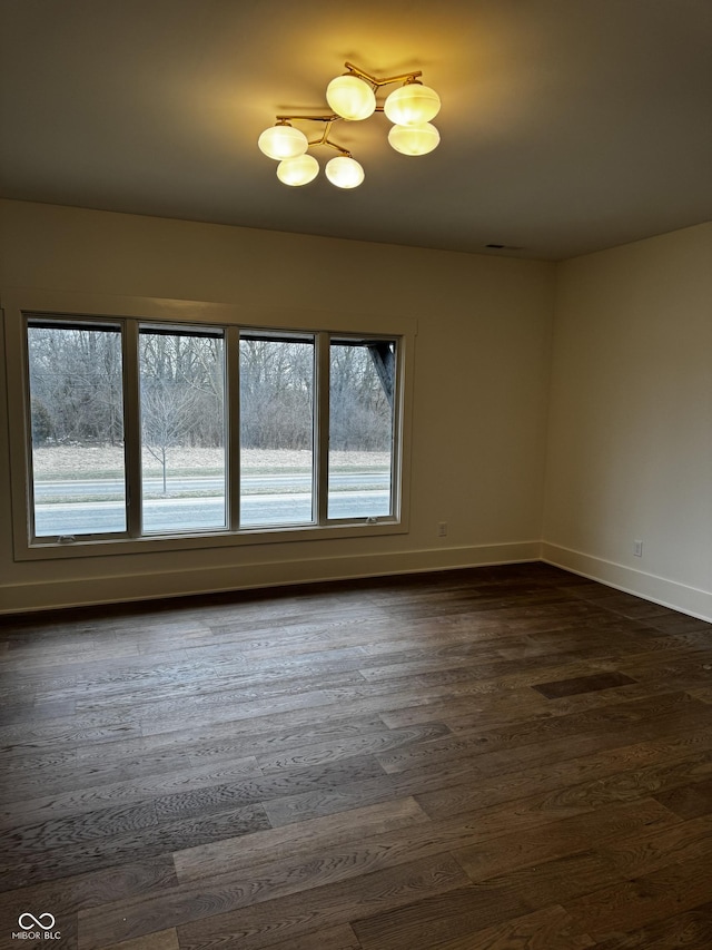 spare room with dark wood-type flooring