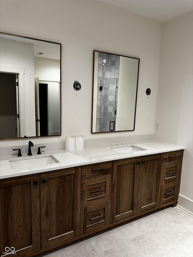 bathroom with vanity and a shower with shower door