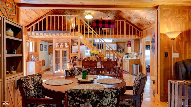 dining space with plenty of natural light, lofted ceiling with beams, light hardwood / wood-style floors, and ceiling fan