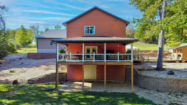 rear view of property featuring a wooden deck