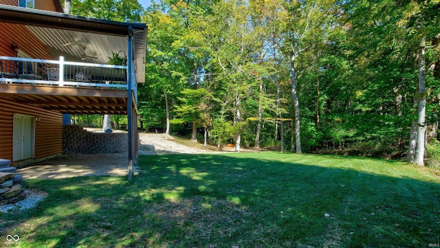 view of yard featuring a balcony and a patio