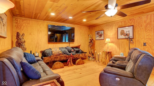 living room featuring wood walls, hardwood / wood-style floors, wood ceiling, and ceiling fan