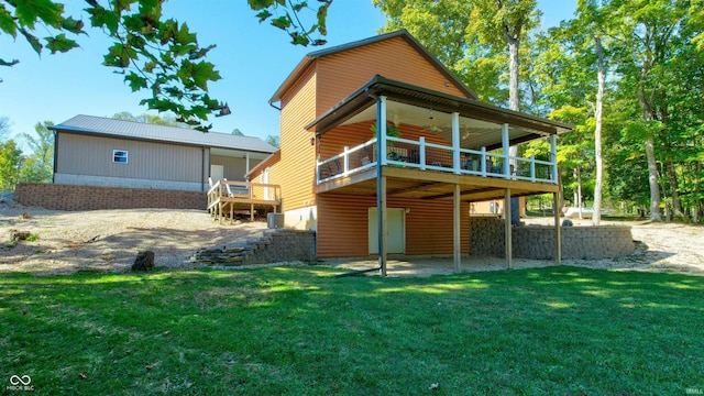 rear view of property with a yard and a deck