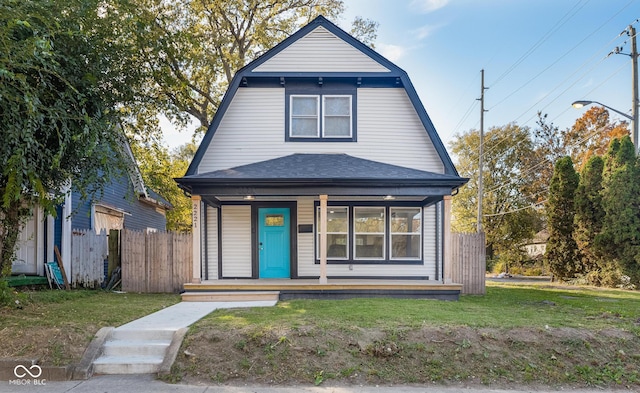 2221 E Michigan St, Indianapolis, IN 46201 - view of front of home featuring a porch, a front yard, a gambrel roof, a shingled roof, and fence