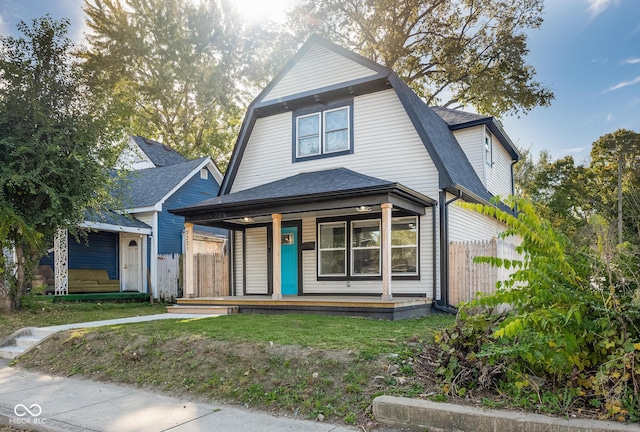 2221 E Michigan St, Indianapolis, IN 46201 - view of front of property with a porch, a gambrel roof, a shingled roof, and fence