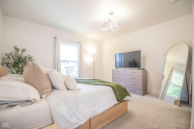 carpeted bedroom featuring multiple windows