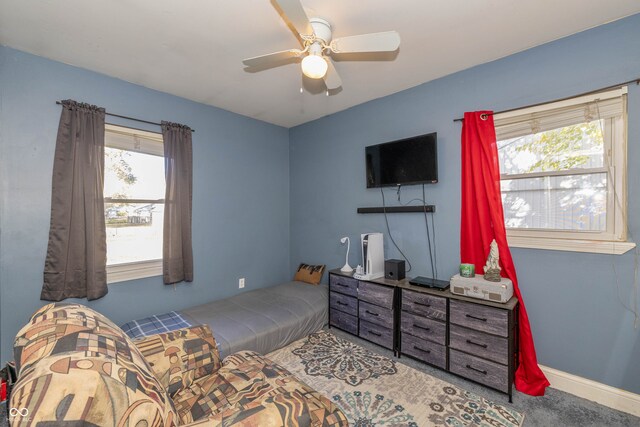 carpeted bedroom with multiple windows and ceiling fan