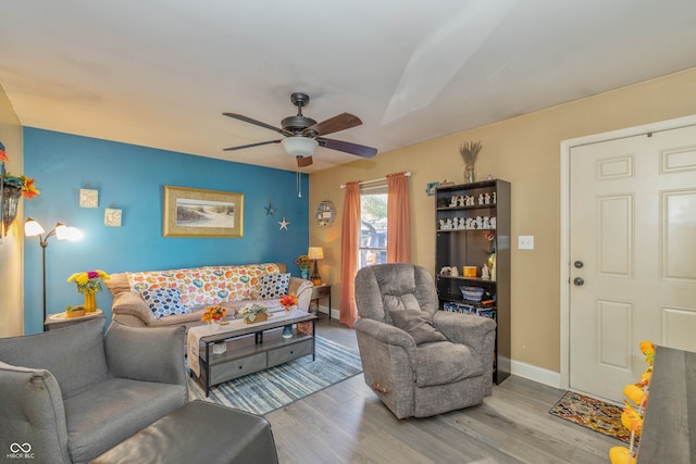 living room with ceiling fan and light wood-type flooring