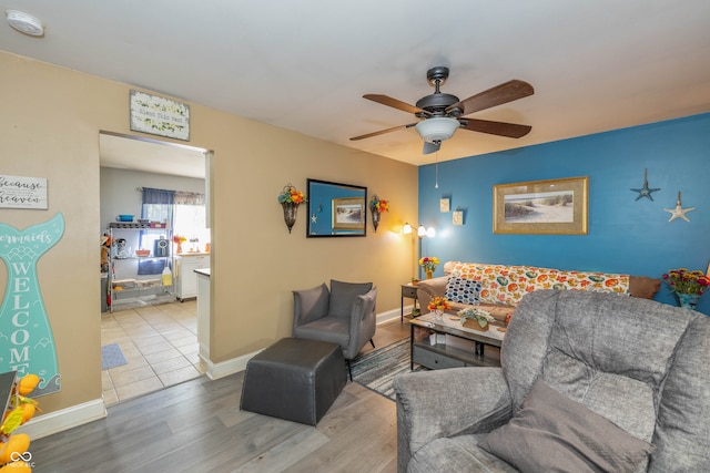 living room with ceiling fan and light hardwood / wood-style flooring