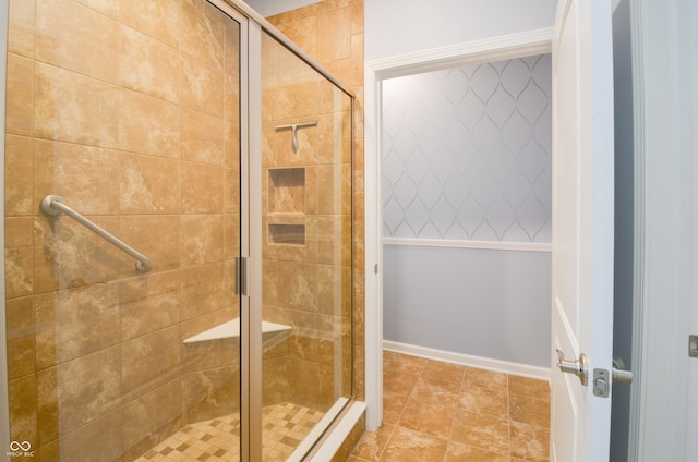 bathroom featuring a shower with door