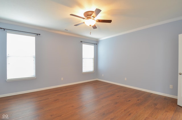 empty room featuring ceiling fan, crown molding, and dark wood-type flooring