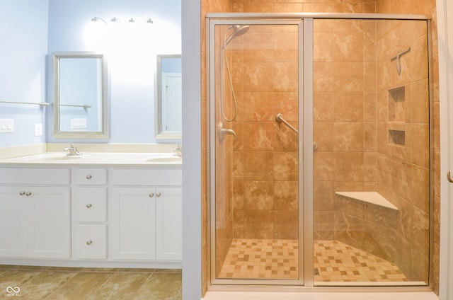 bathroom featuring tile patterned floors, vanity, and an enclosed shower